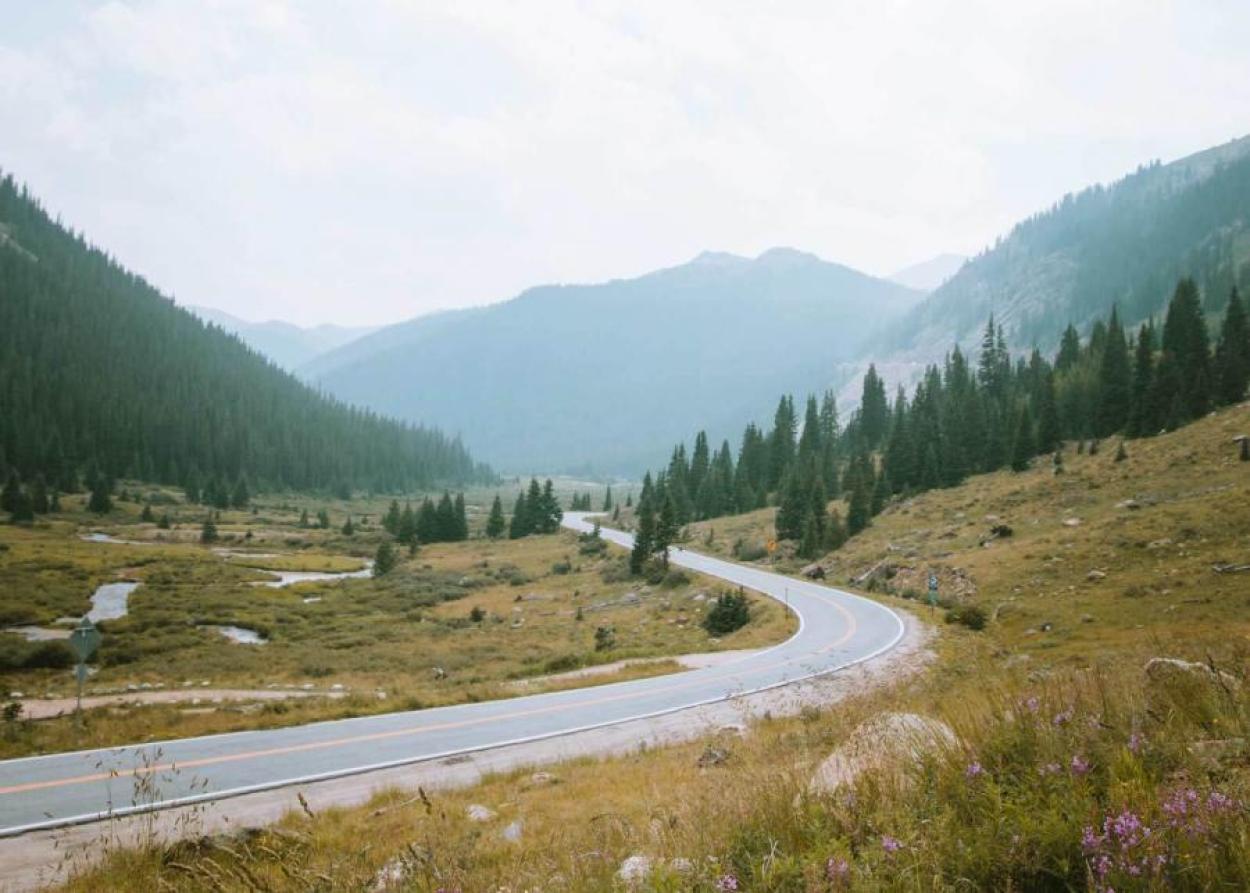 Curving road in front of a mountain on the Million Dollar Highway in Ouray