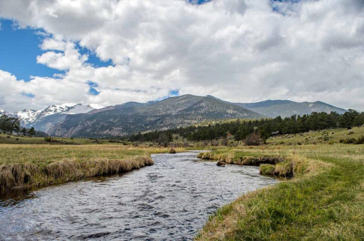 Rushing creek with a mountain in the distance in Rocky Mountain National Park