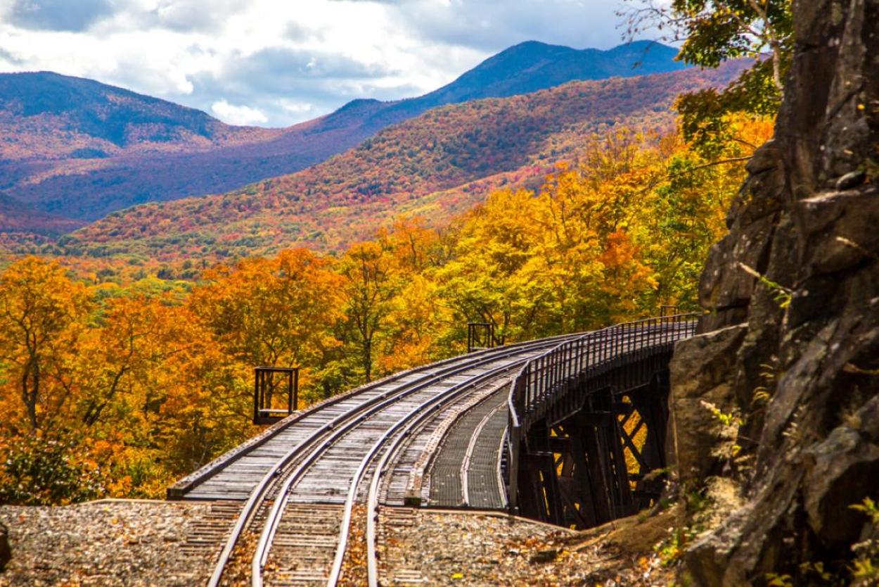 Train bridge through autumn foliage in New Hampshire