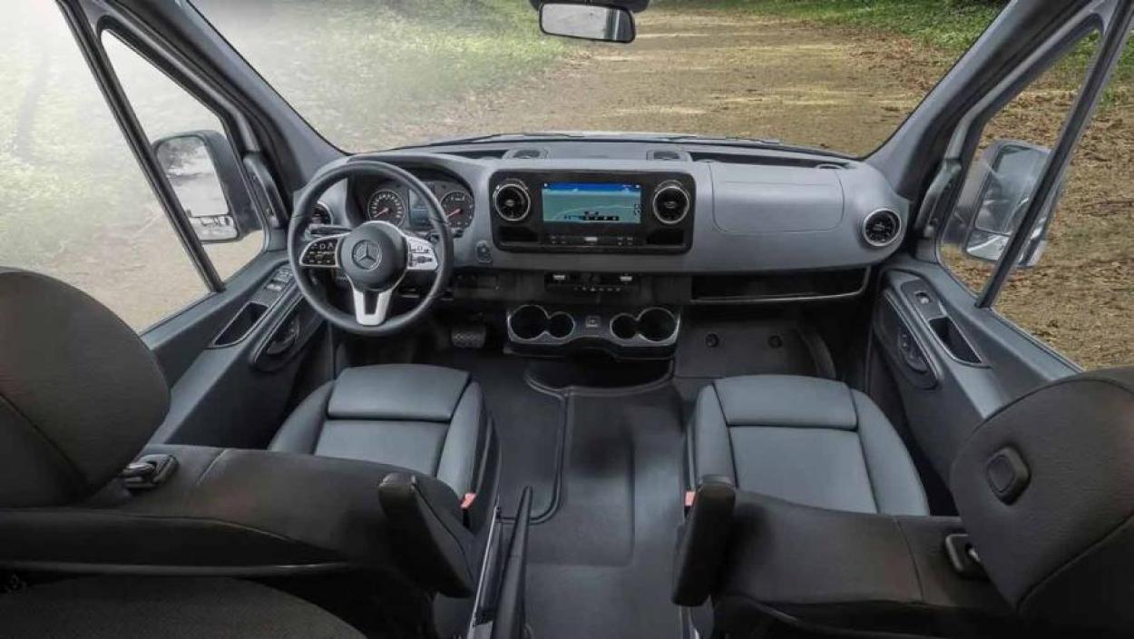 Cockpit inside the Winnebago Revel campervan featuring black finishes and black interior seating