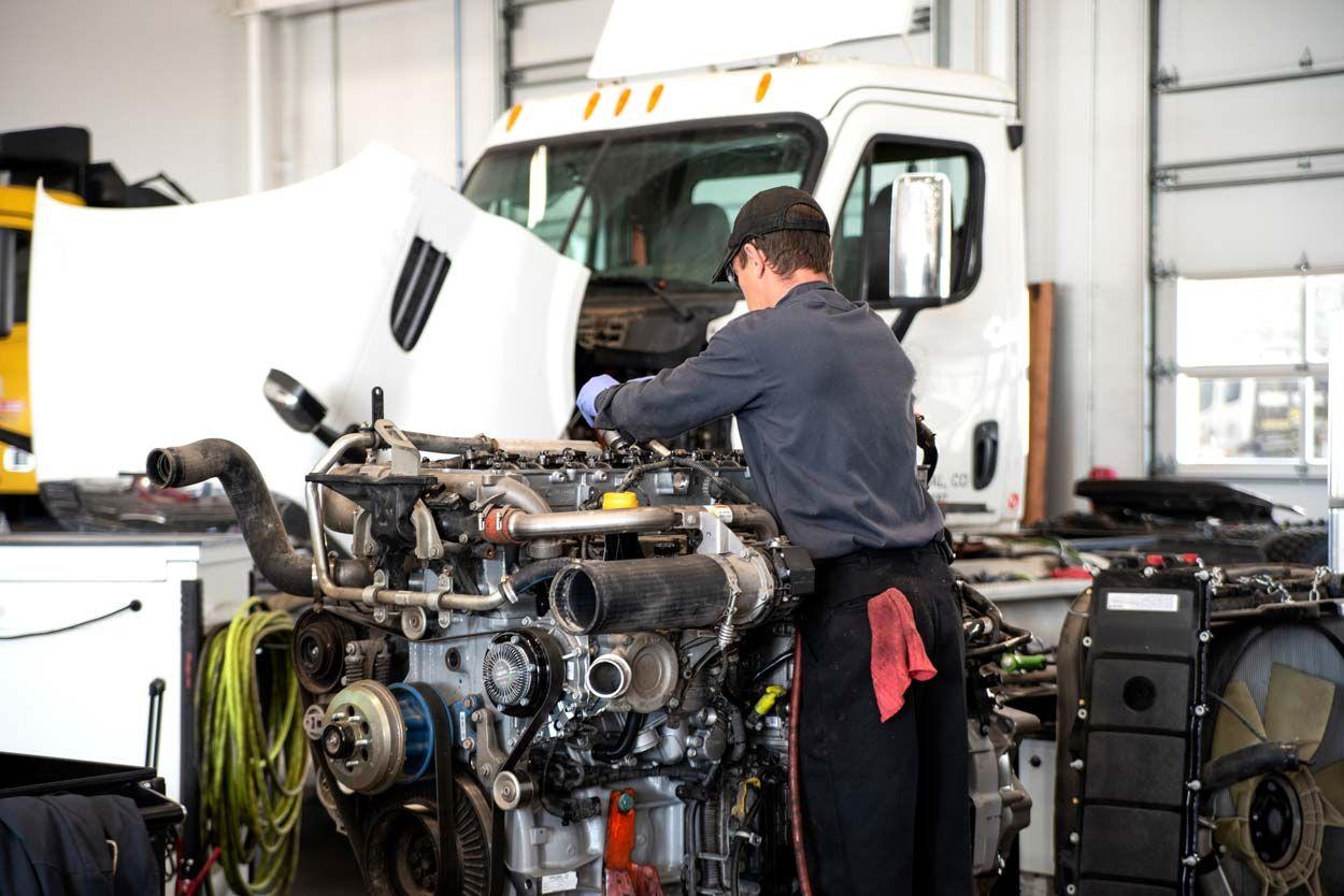 Man working on a diesel engine