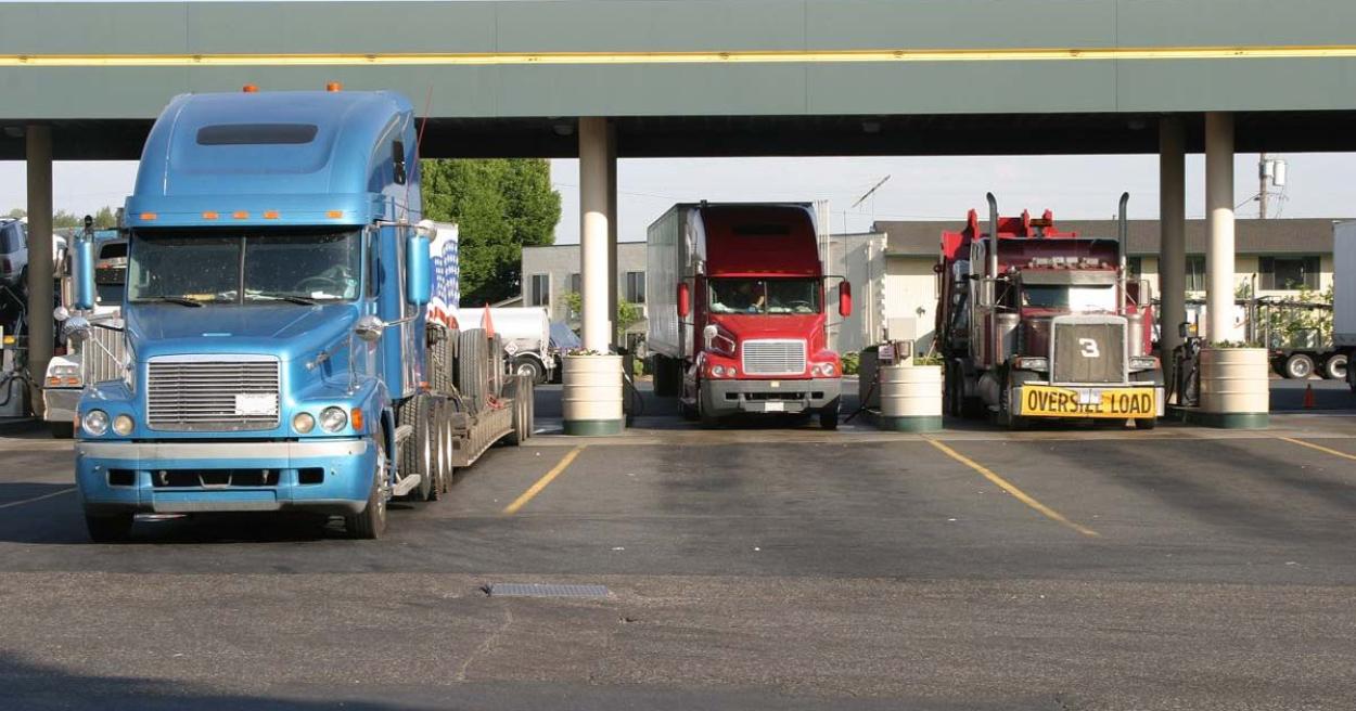 Commercial trucks at a refueling station