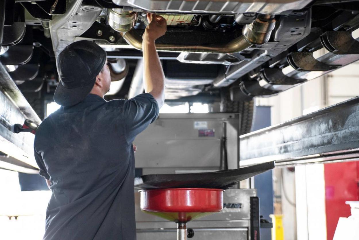 man working on the underside of an RV