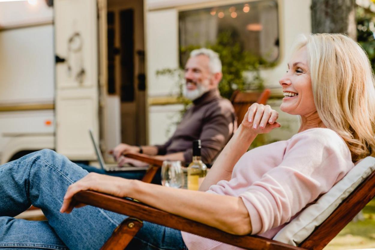 Mature couple sitting outside an RV