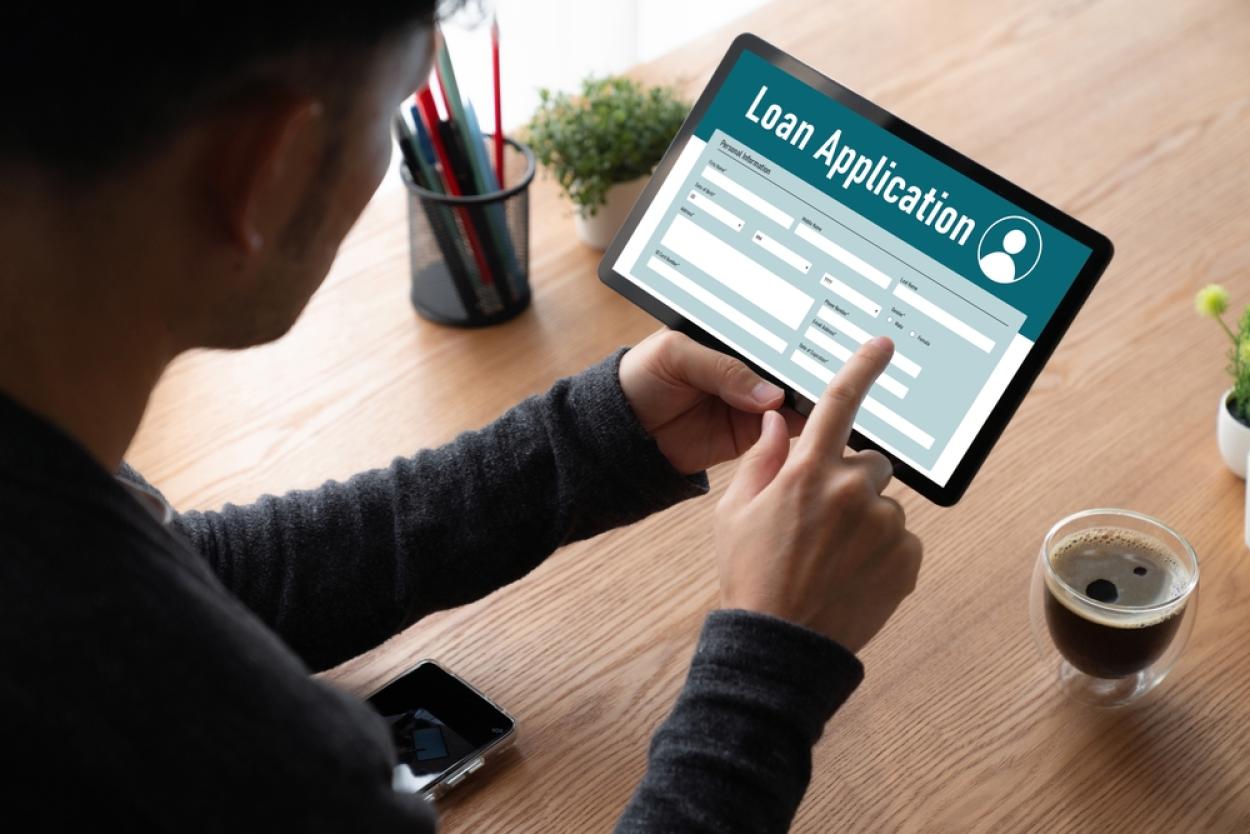 Person looks at loan application on a tablet