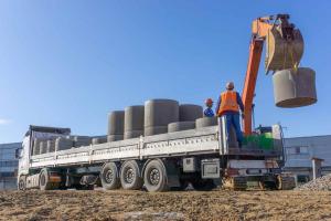 Concrete being loaded onto a commercial trailer on a construction site