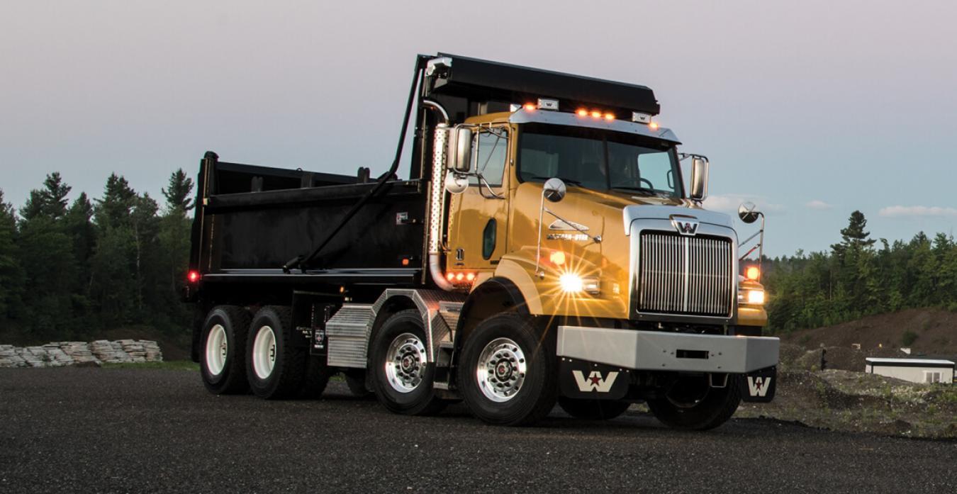 Western Star Truck Driving Down Road at Dusk