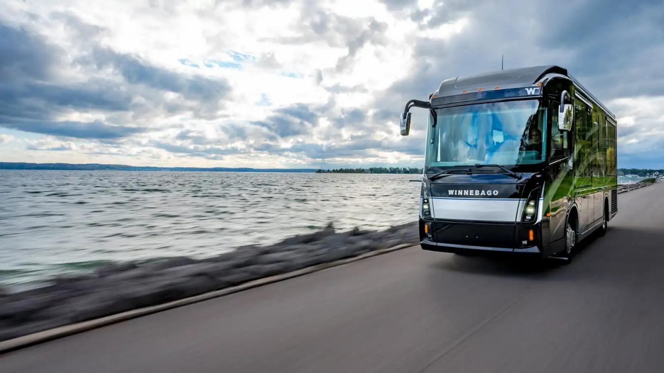 Winnebago RV driving along a coast