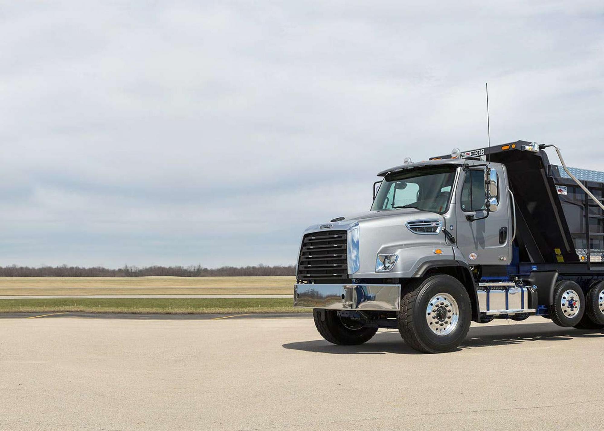 Freightliner truck parked in front of the sky