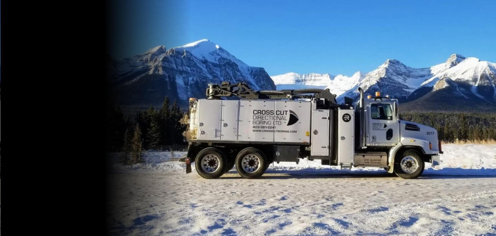 Rival truck with snow covered mountains