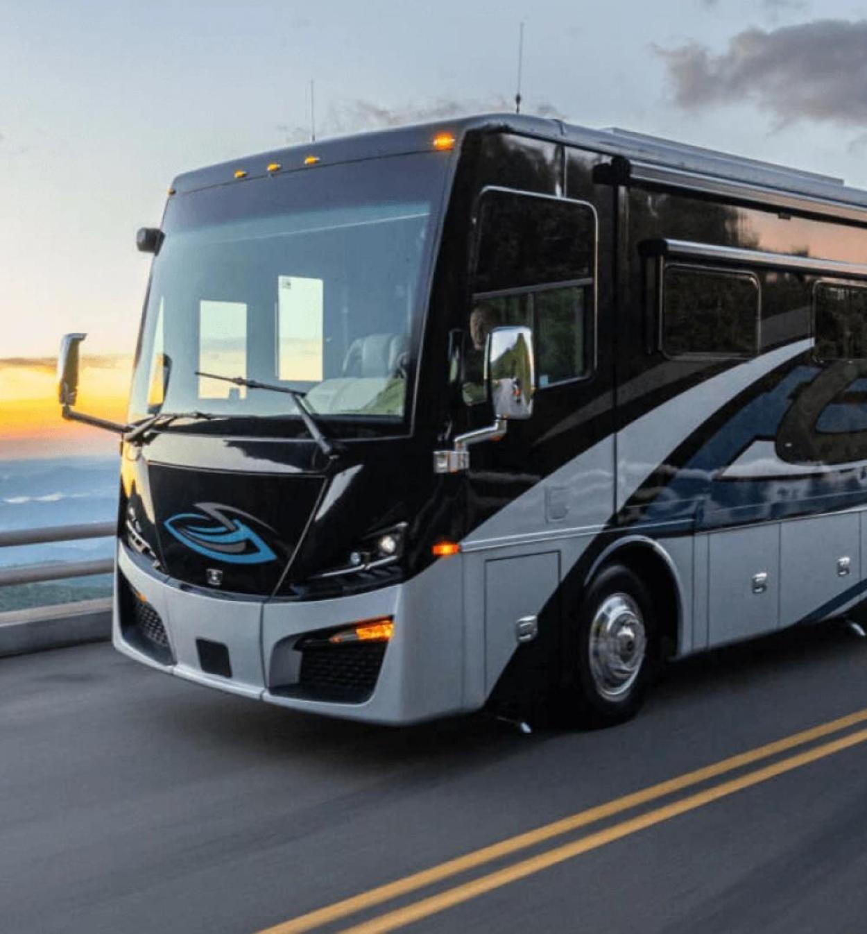 A black RV with white and dark-blue accents