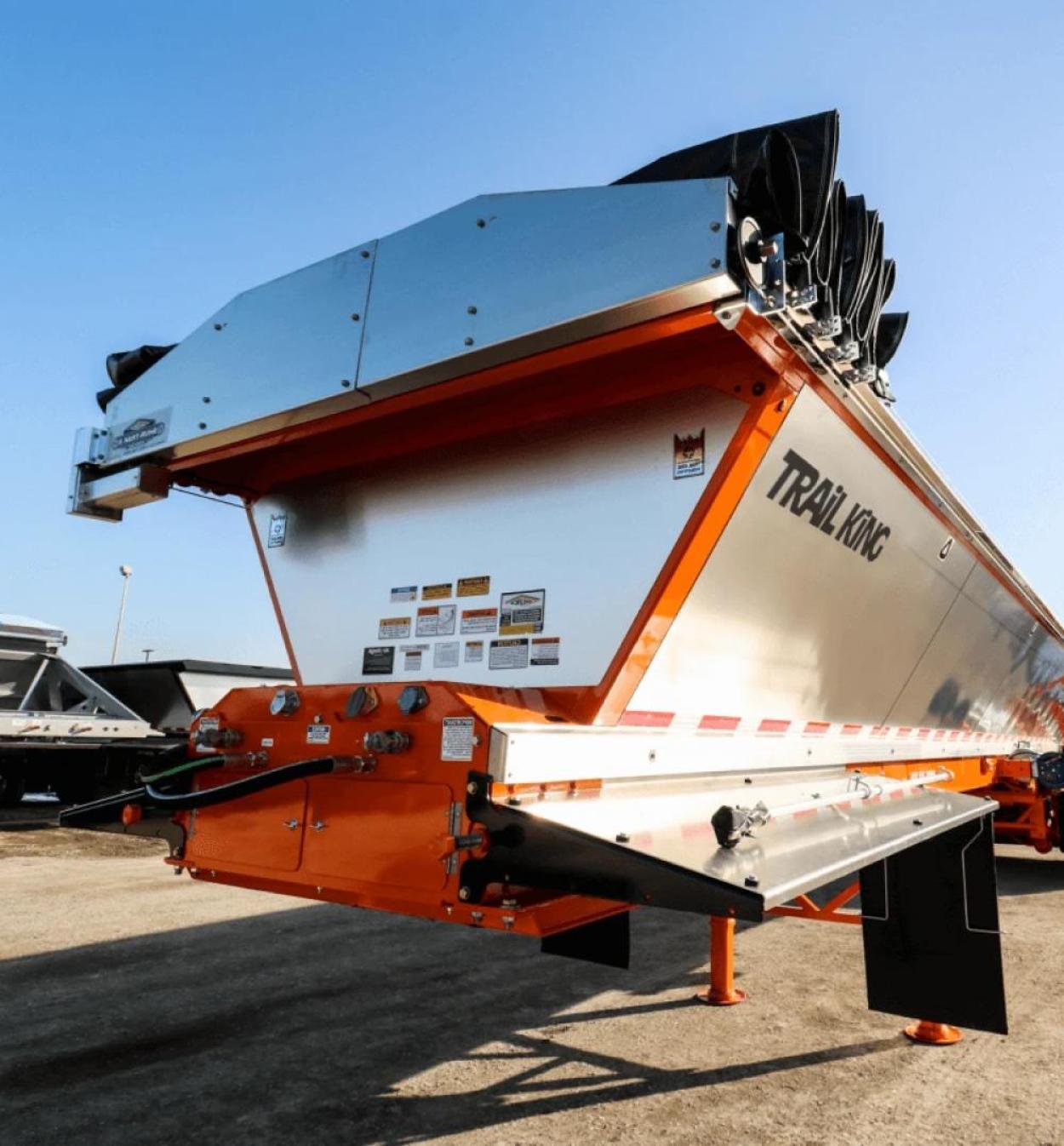 An unattached red and silver trailer