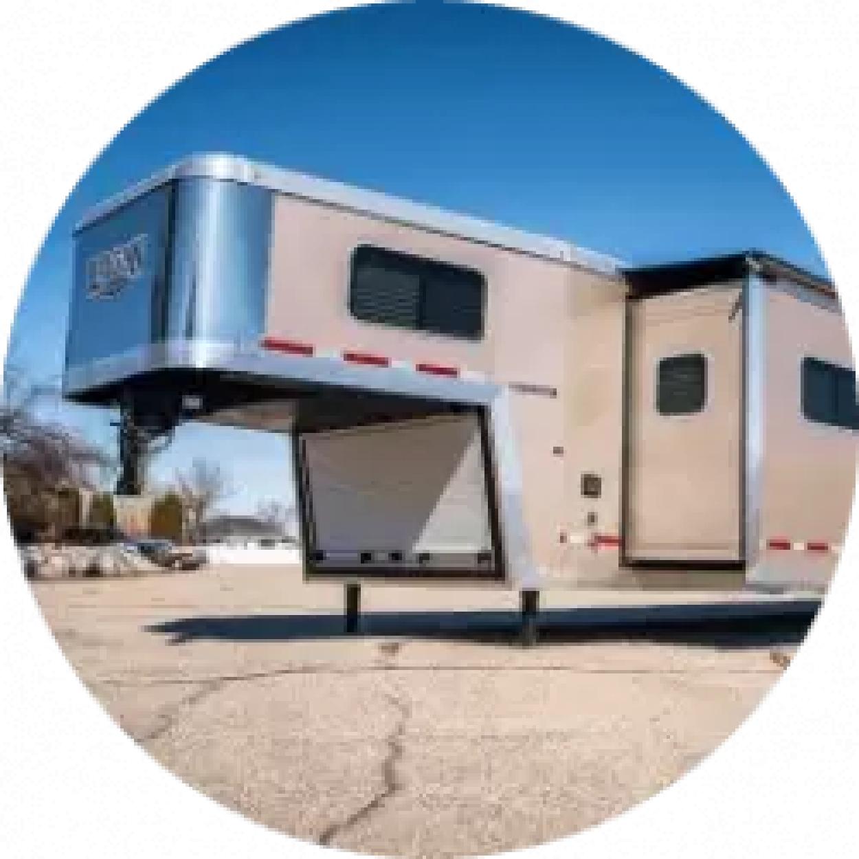 An unattached livestock trailer in an empty lot