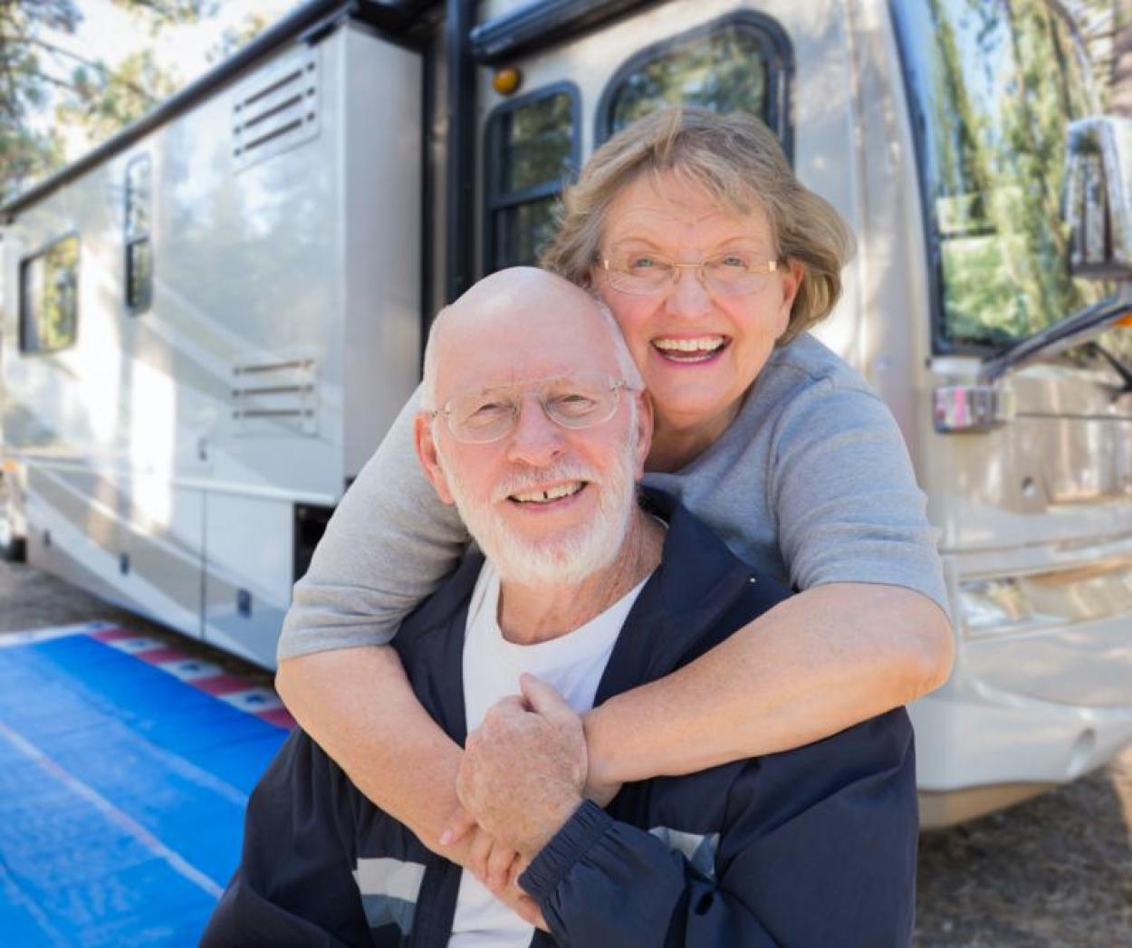 Couple posing in front of an RV